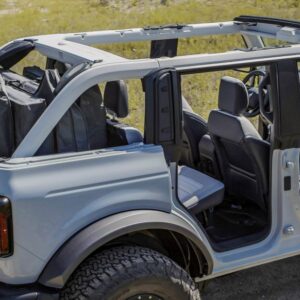 Every Bronco comes with class-exclusive frameless doors that make them easier to remove than what competitors offer. On four-door 2021 Bronco models, all four doors can be stored onboard with protective door bags. Rear quarter windows are also removable, as shown in this four-door Bronco prototype and all will have exclusive cowl-mounted mirrors maintain sideview visibility when the doors are removed. (Prototype not representative of production vehicle.)